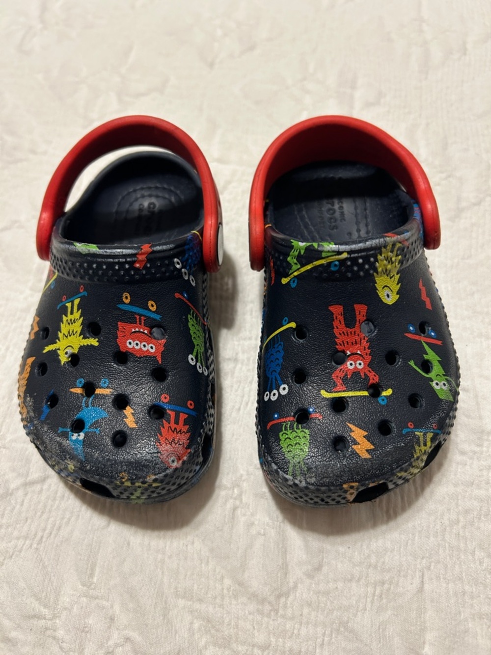 CROCS Kids Monster Print Navy Clog with Red Strap, Size C6.